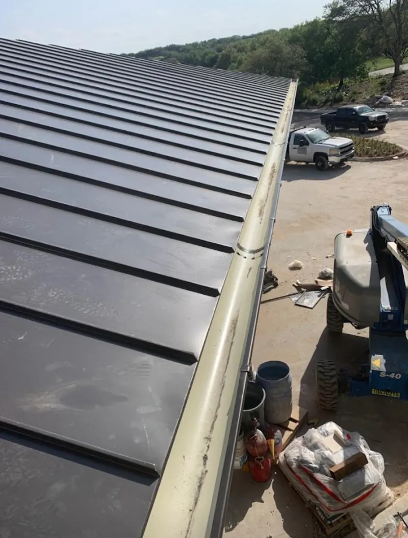 Standing seam panel and gutter detail on a metal roofing jobsite in Wahiawa